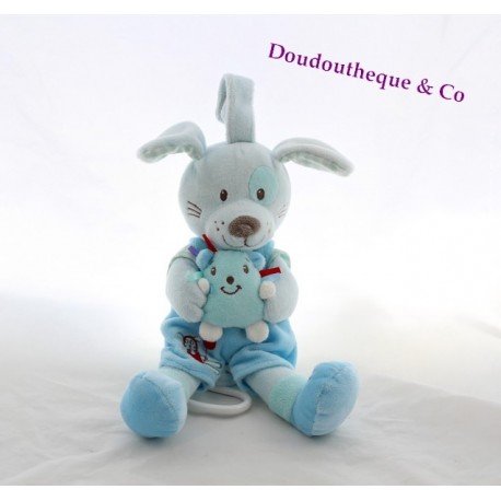 Doudou musical chien TEX BABY cocard et doudou dans les mains 25 cm