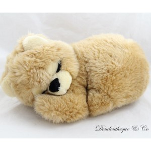 Brown sleeper bear plush lying down with eyes closed